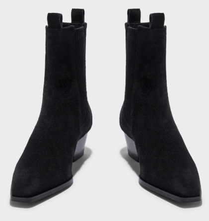 A pair of black suede Chelsea-style ankle boots with low block heels and pull tabs, shown from a front-facing angle on a light gray background.