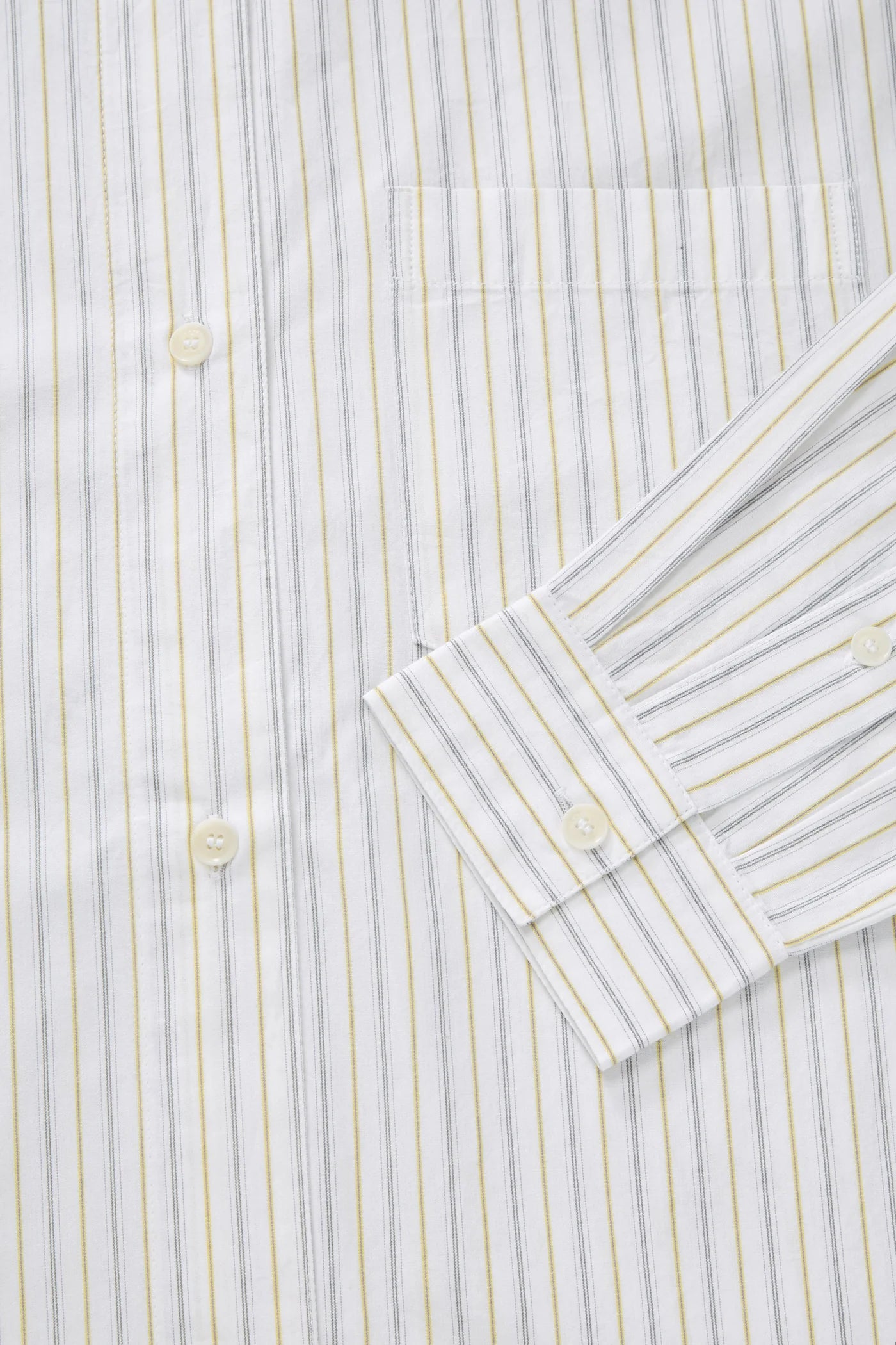 Close-up of a striped shirt with a focus on the collar and buttons.