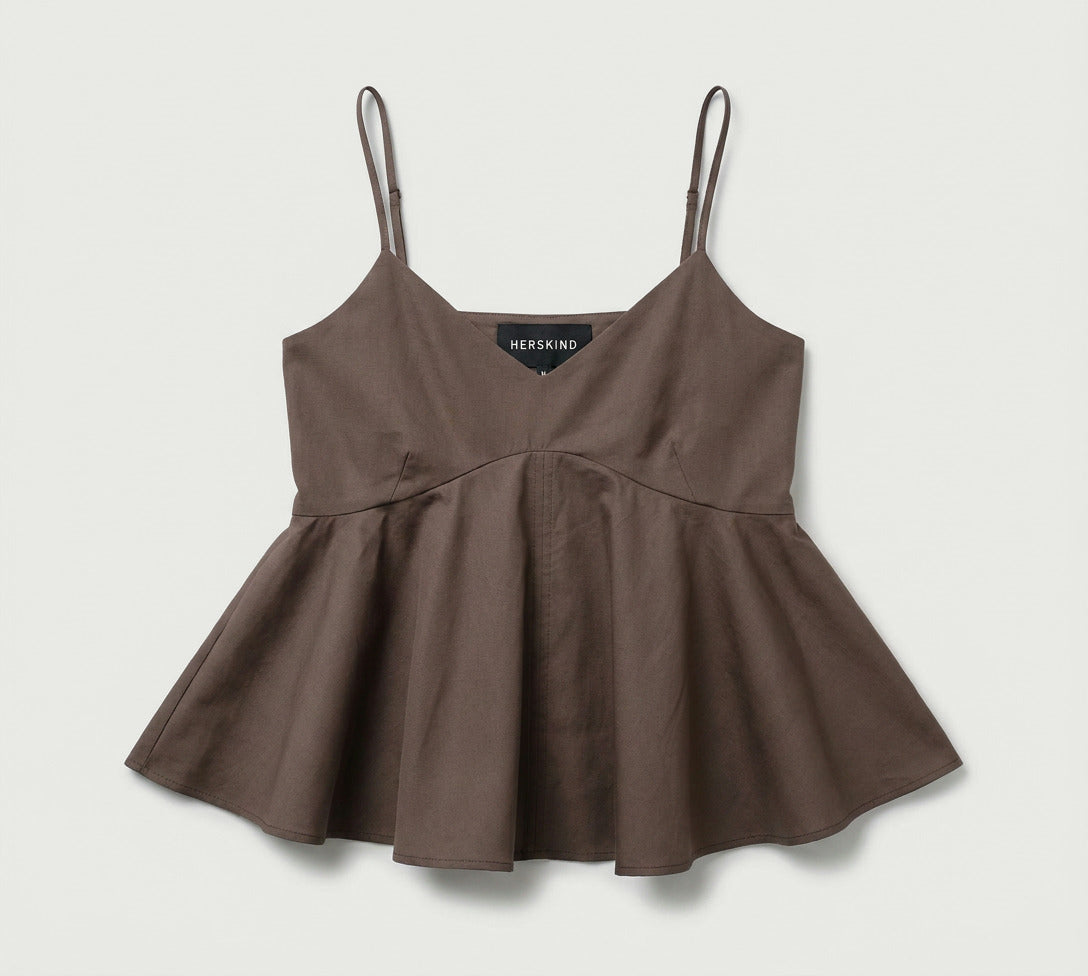 Brown peplum top with thin straps on a light gray background