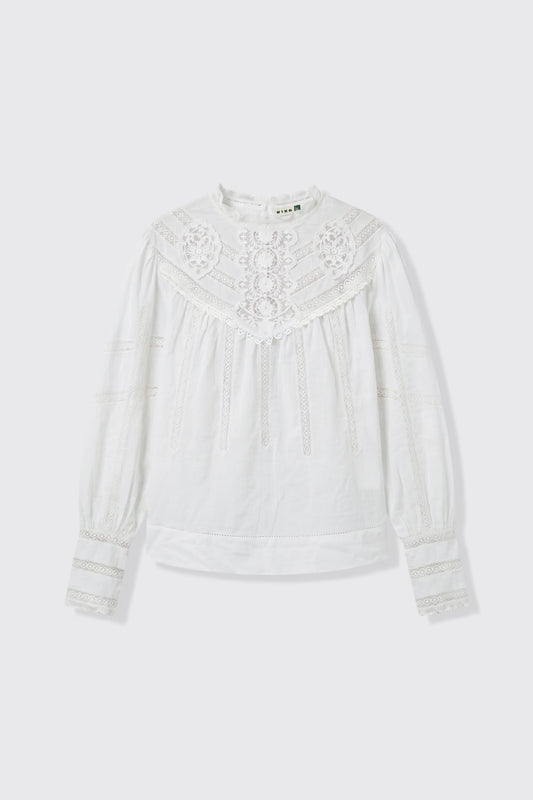 A white long-sleeve blouse with intricate lace and embroidery on the yoke and cuffs, displayed flat against a light gray background.