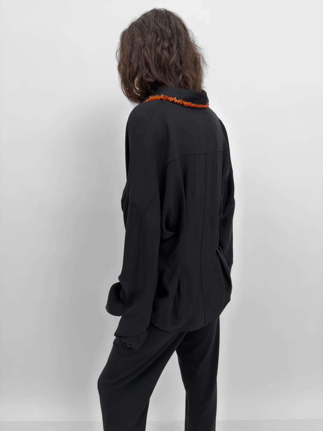 Person wearing a black outfit with a white background