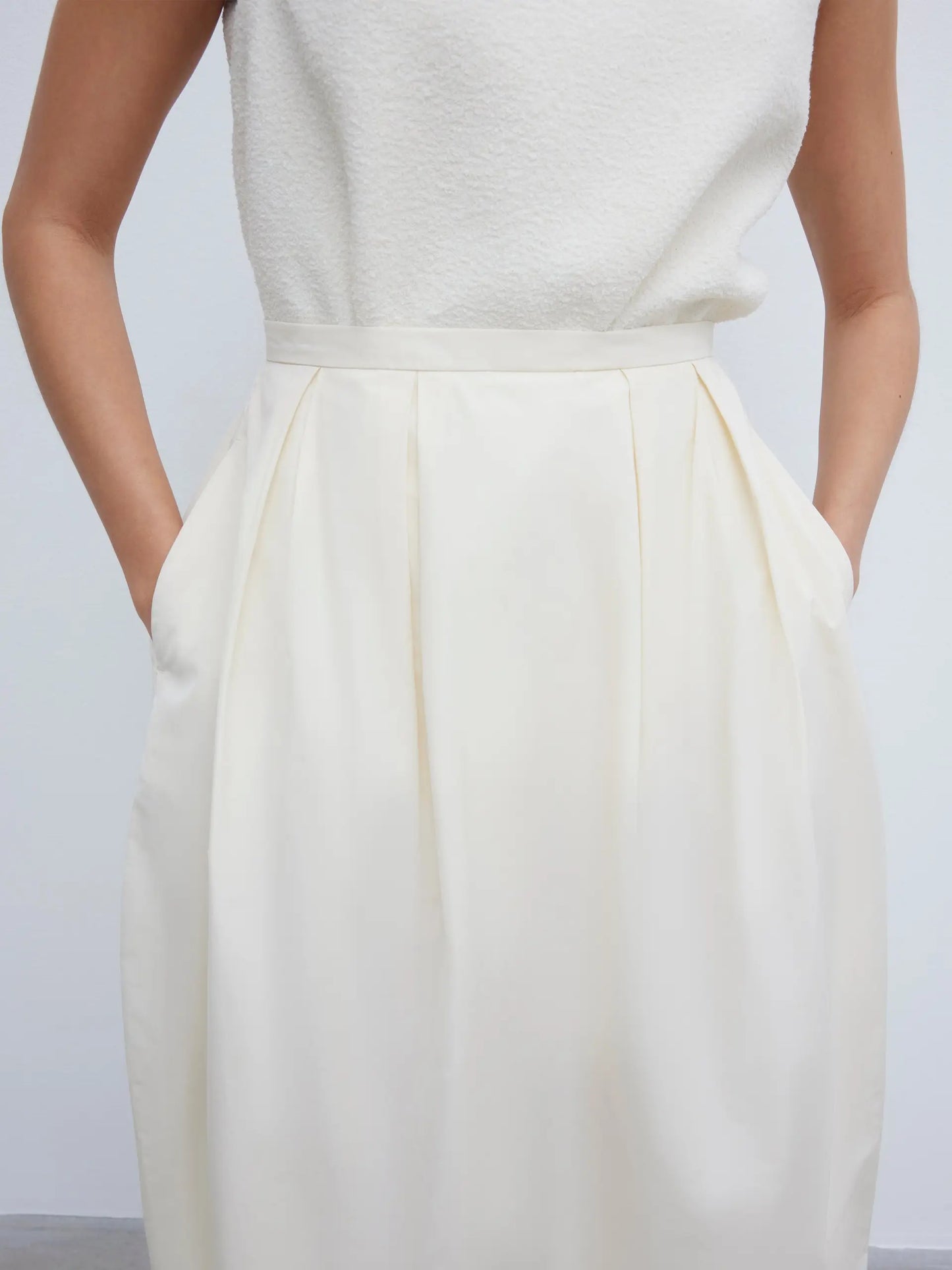 Curved pleated skirt