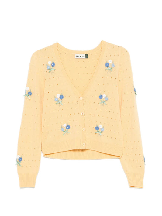 Yellow sweater with floral embroidery on a white background