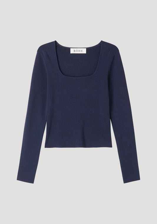 Navy long-sleeve top on a light gray background