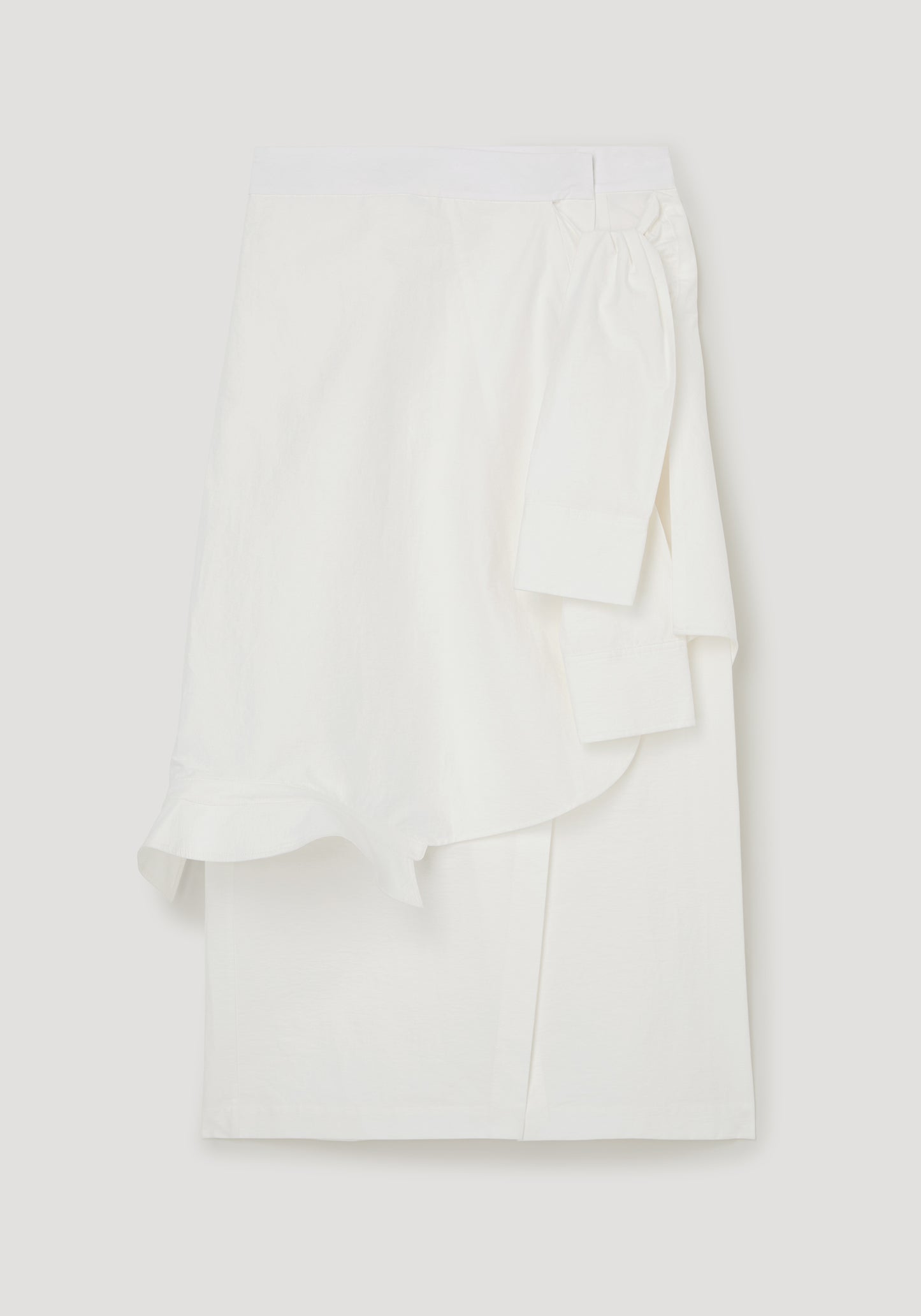 White blouse with ruffled details on a light gray background