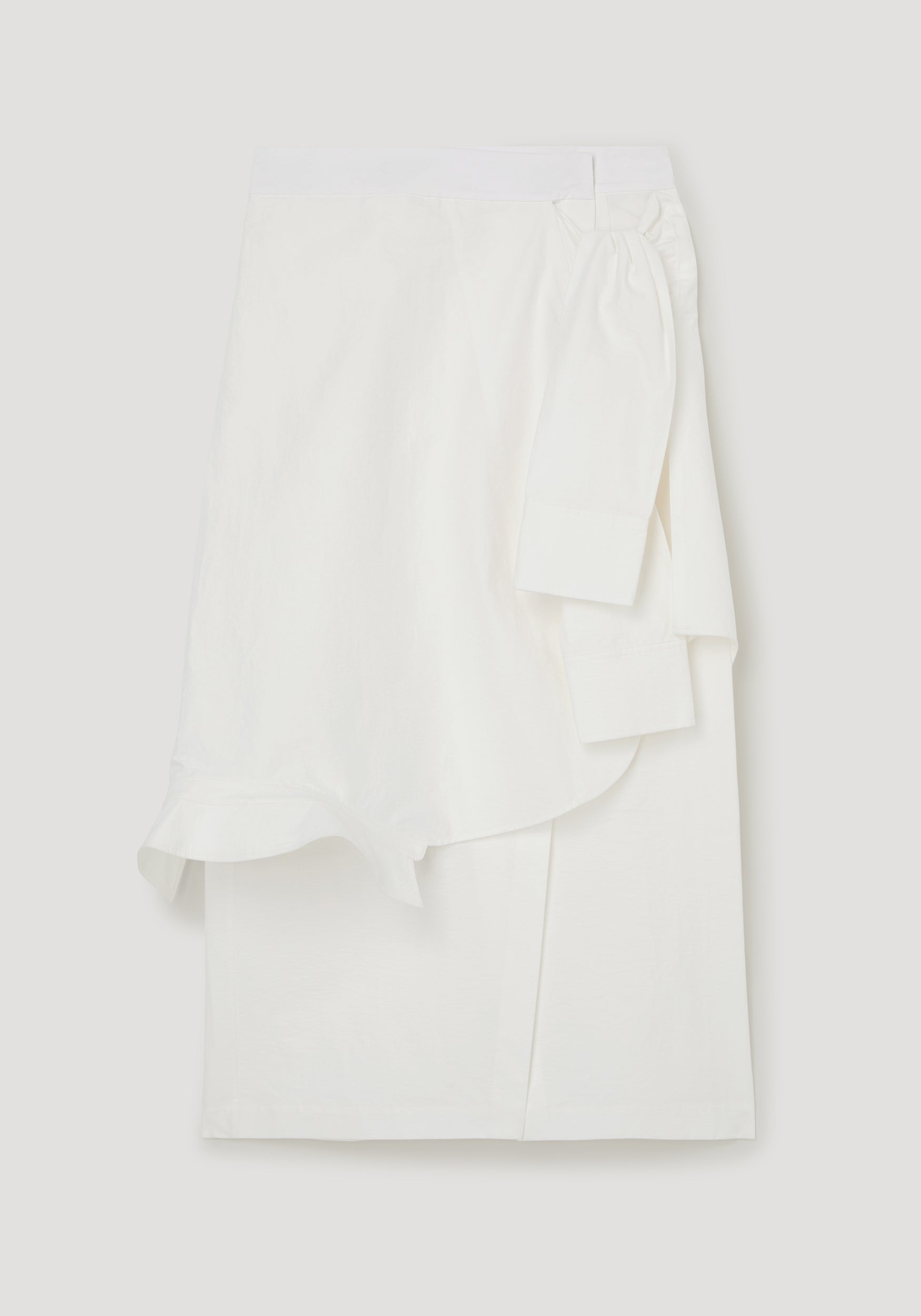 White blouse with ruffled details on a light gray background