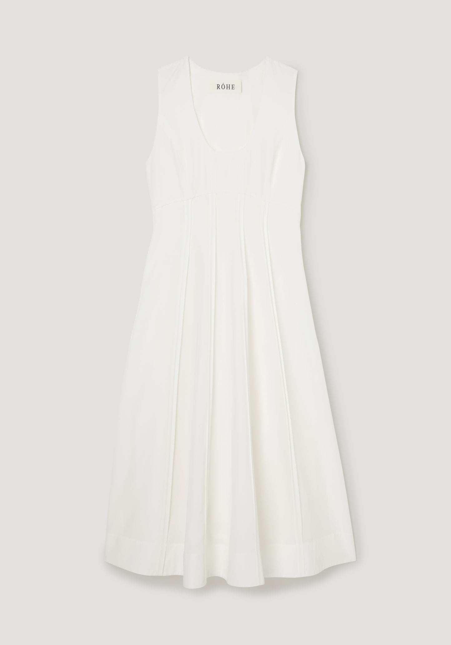 White dress with a brand label on a light gray background