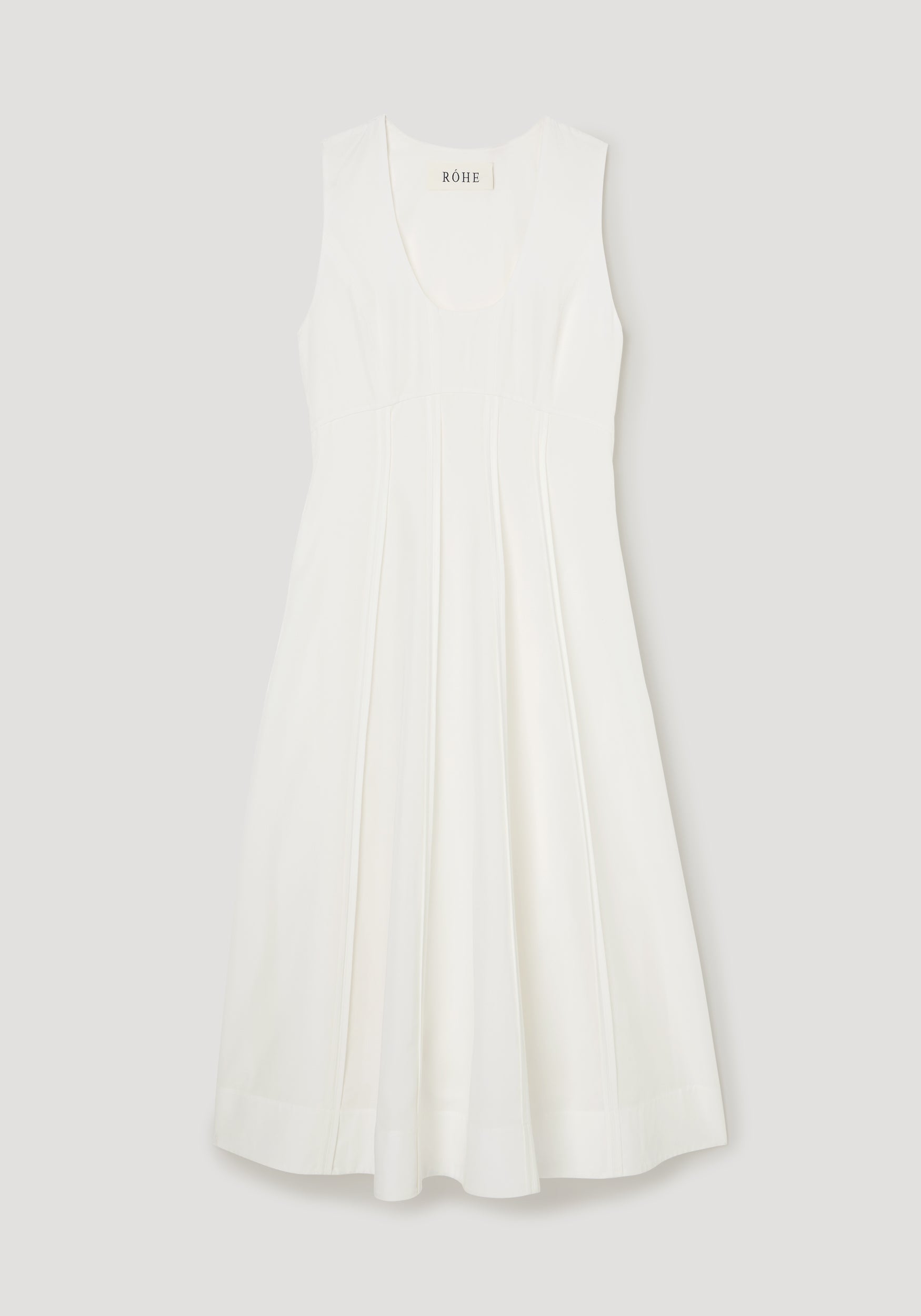 White dress with a brand label on a light gray background