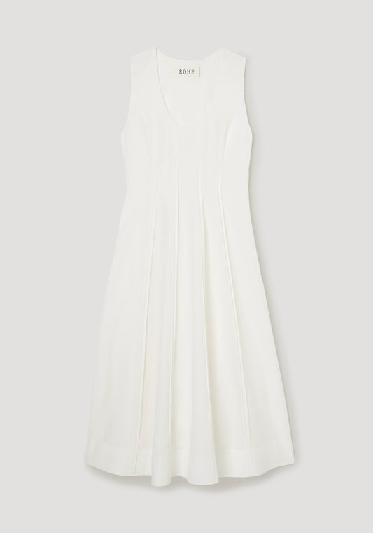 White dress with a brand label on a light gray background