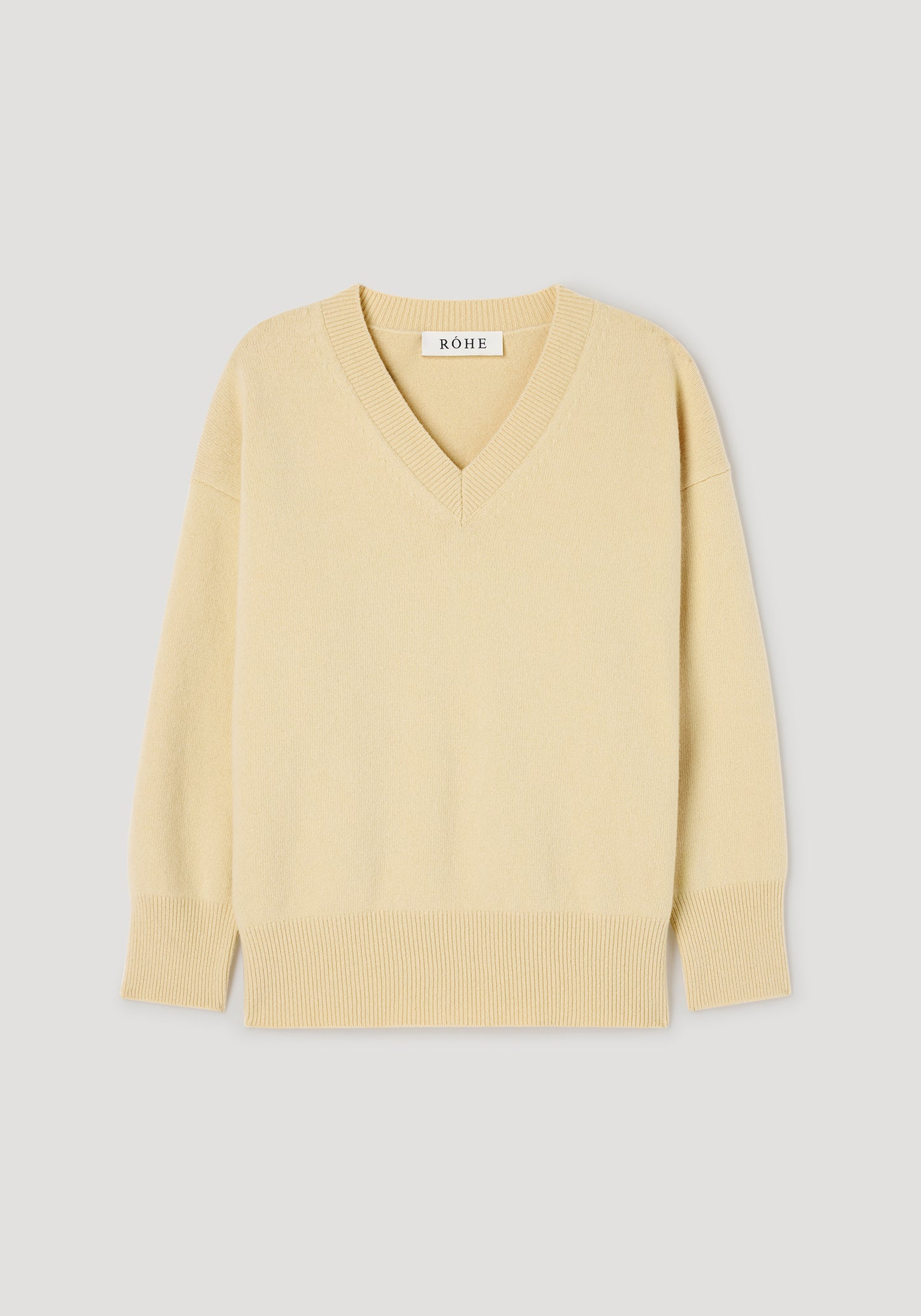 A pale yellow V-neck knit sweater with ribbed trim at the collar, cuffs, and hem, displayed flat against a light gray background. The brand name 'NOWE' is visible on the inner neck label.