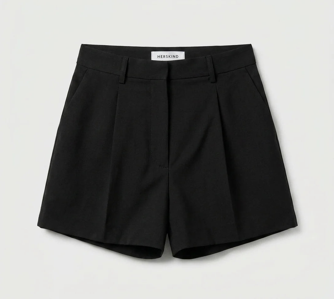 Black shorts with a visible brand label on a light gray background
