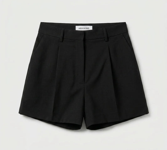 Black shorts with a visible brand label on a light gray background