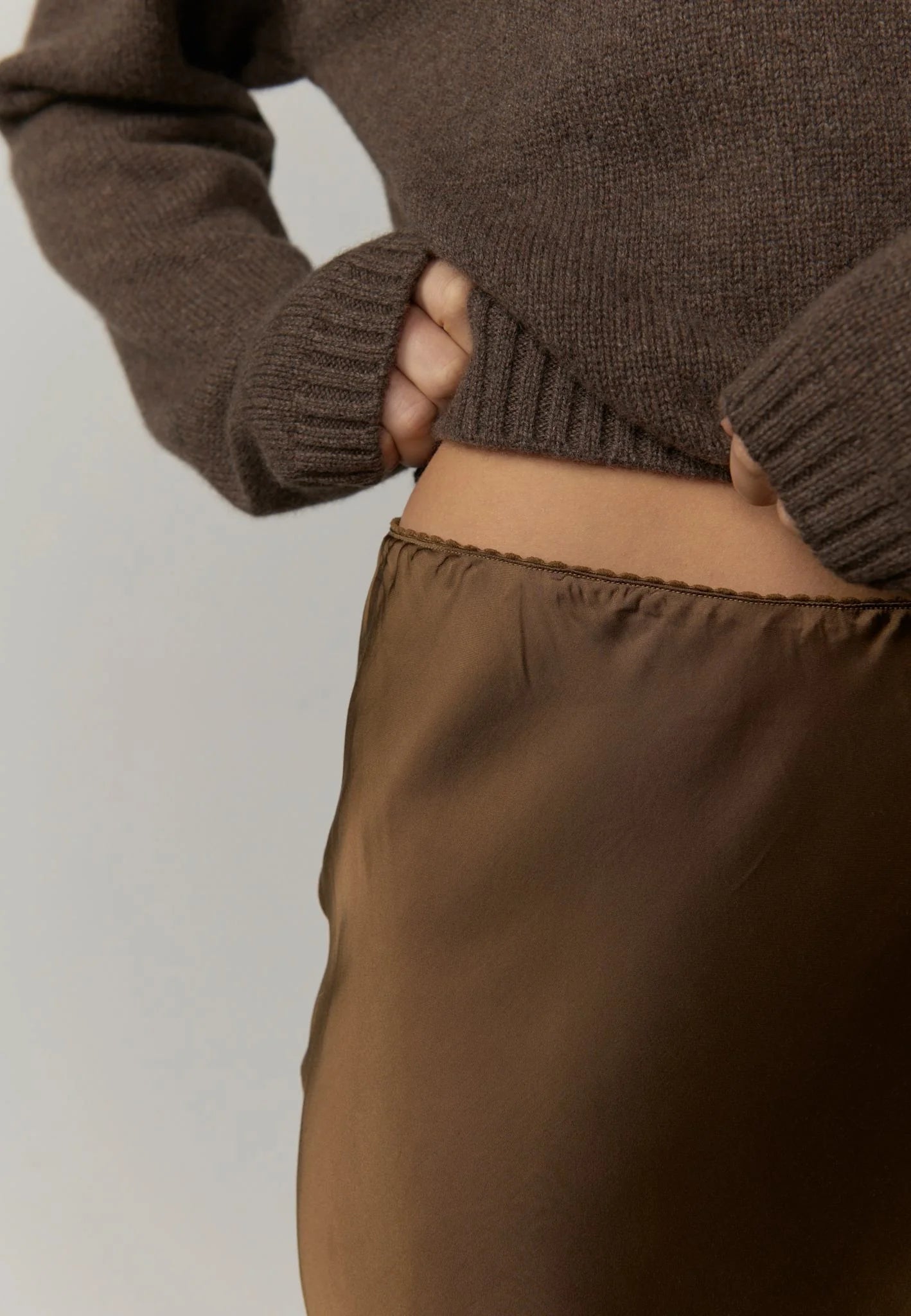 Brown sweater and pants on a plain background