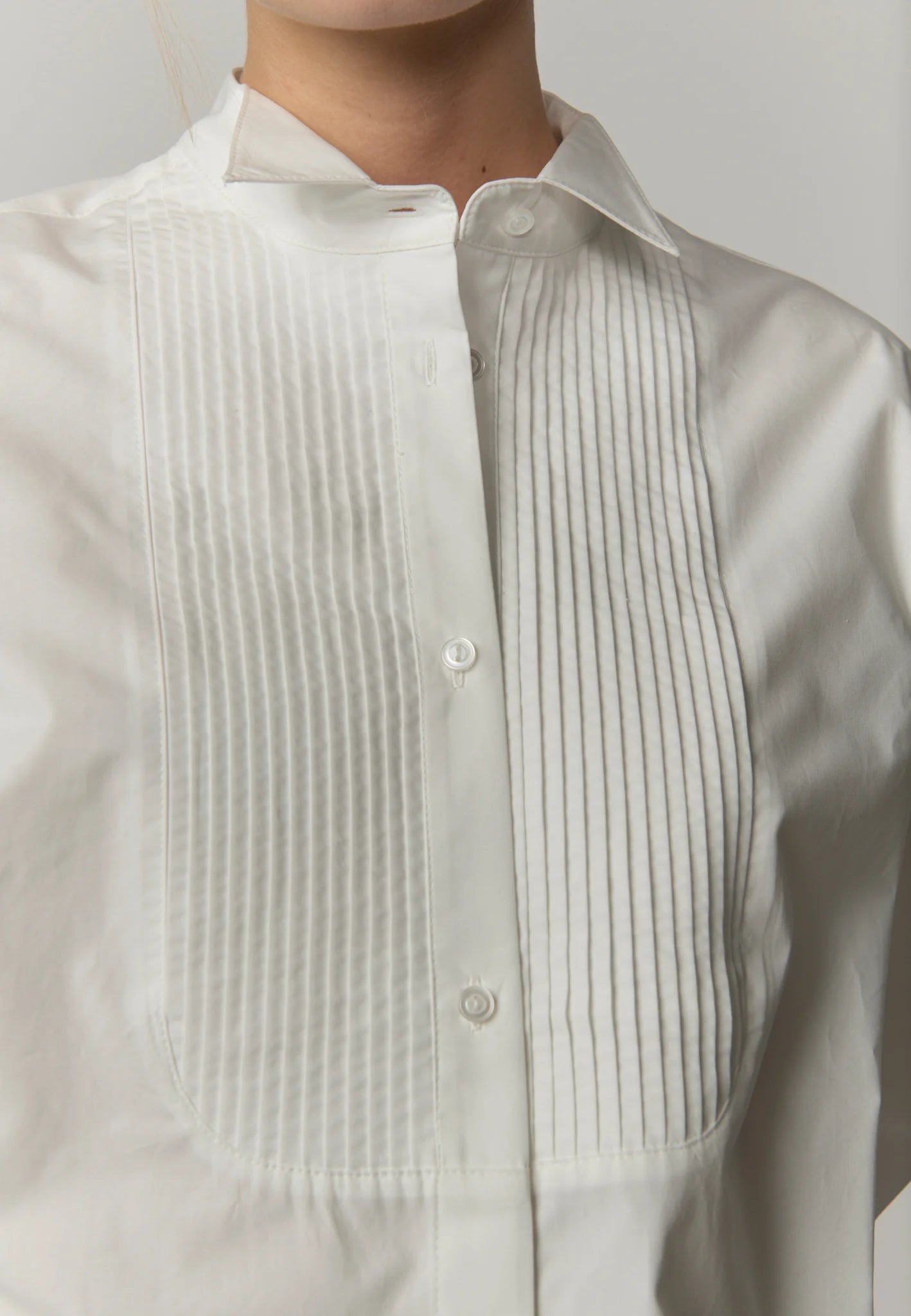 Close-up of the band collar and pintuck detailing