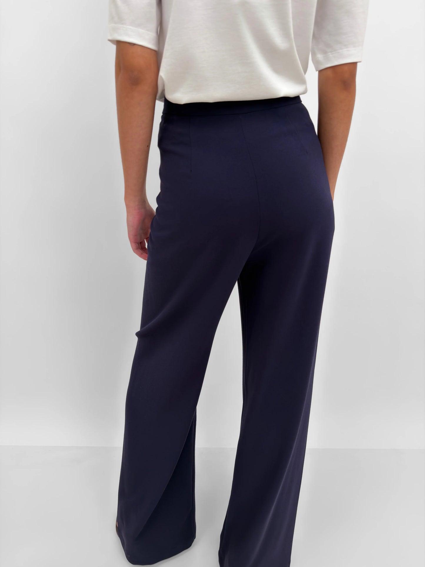 Navy wide-leg pants worn by a person on a white background