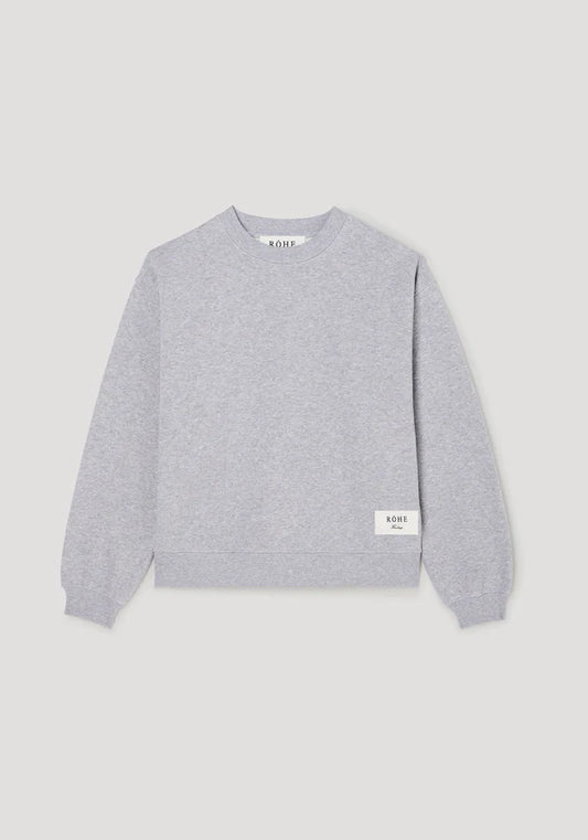 Gray sweater with brand logo on a light gray background