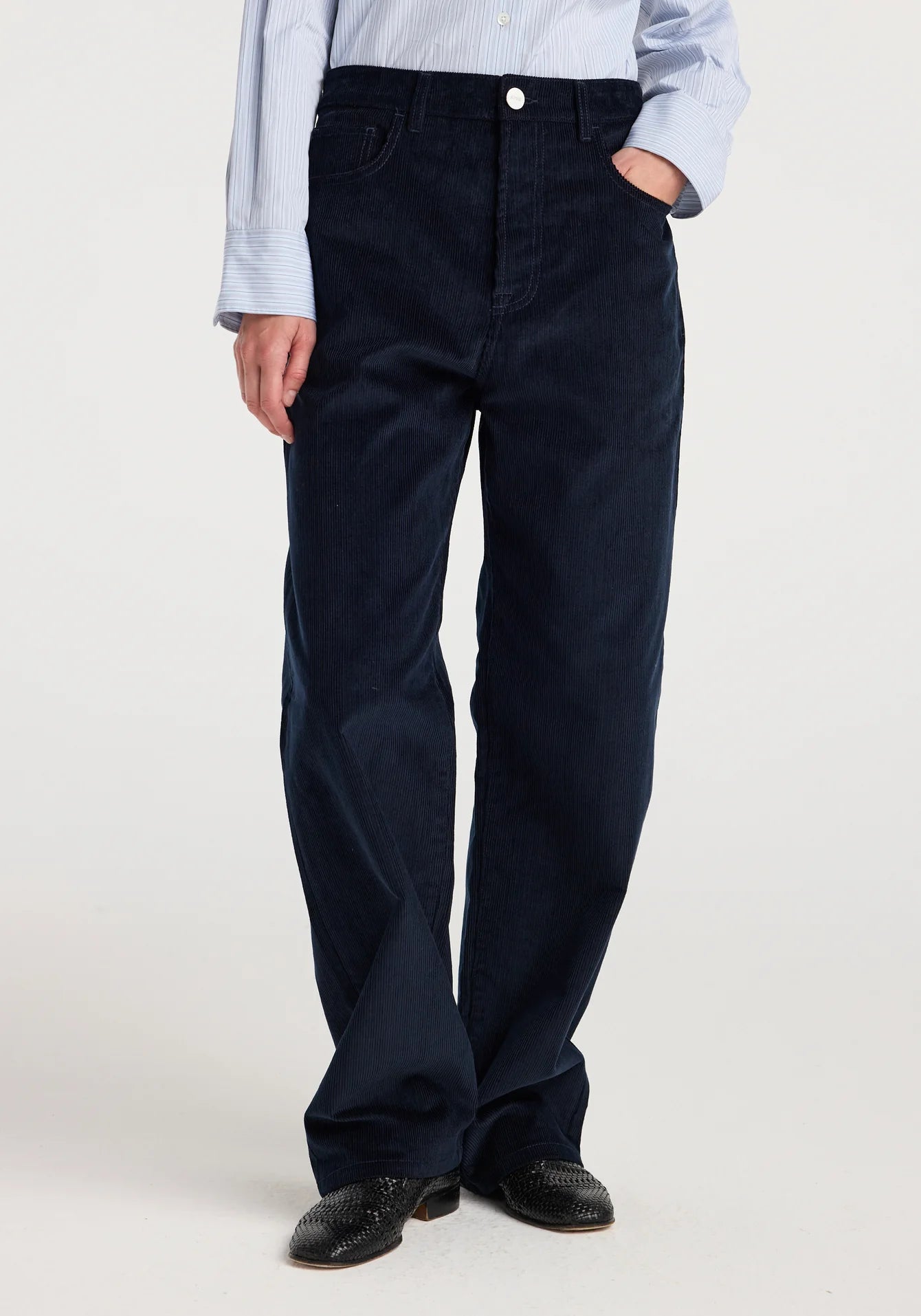 Person wearing navy blue pants on a white background