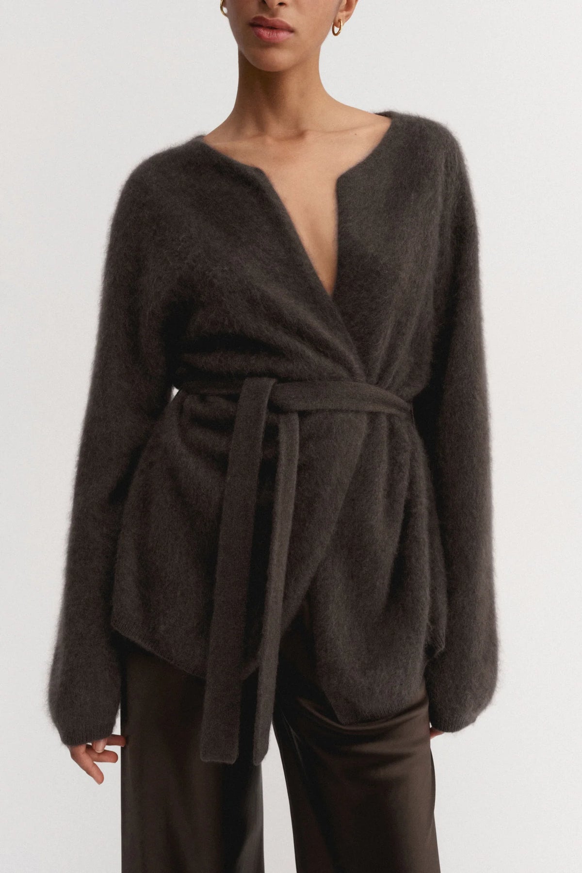 Dark brown wrap sweater worn by a model on a white background