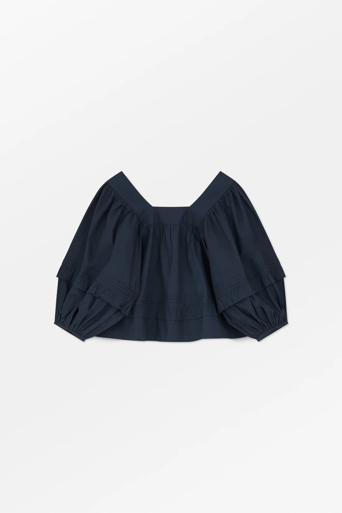 Navy blue top with balloon sleeves on a light gray background