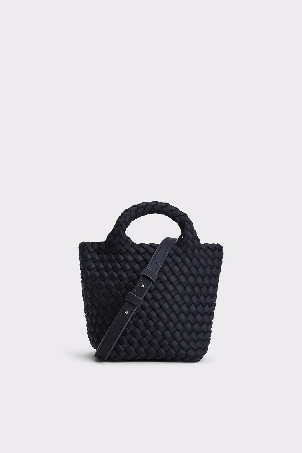 Black woven handbag with a strap on a light gray background