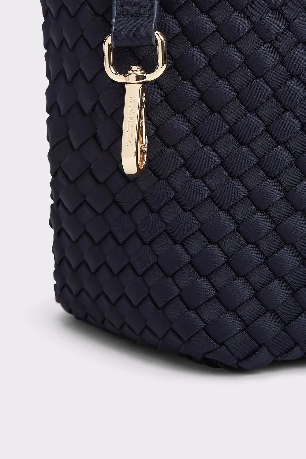 Navy blue woven handbag with a gold clasp on a light gray background