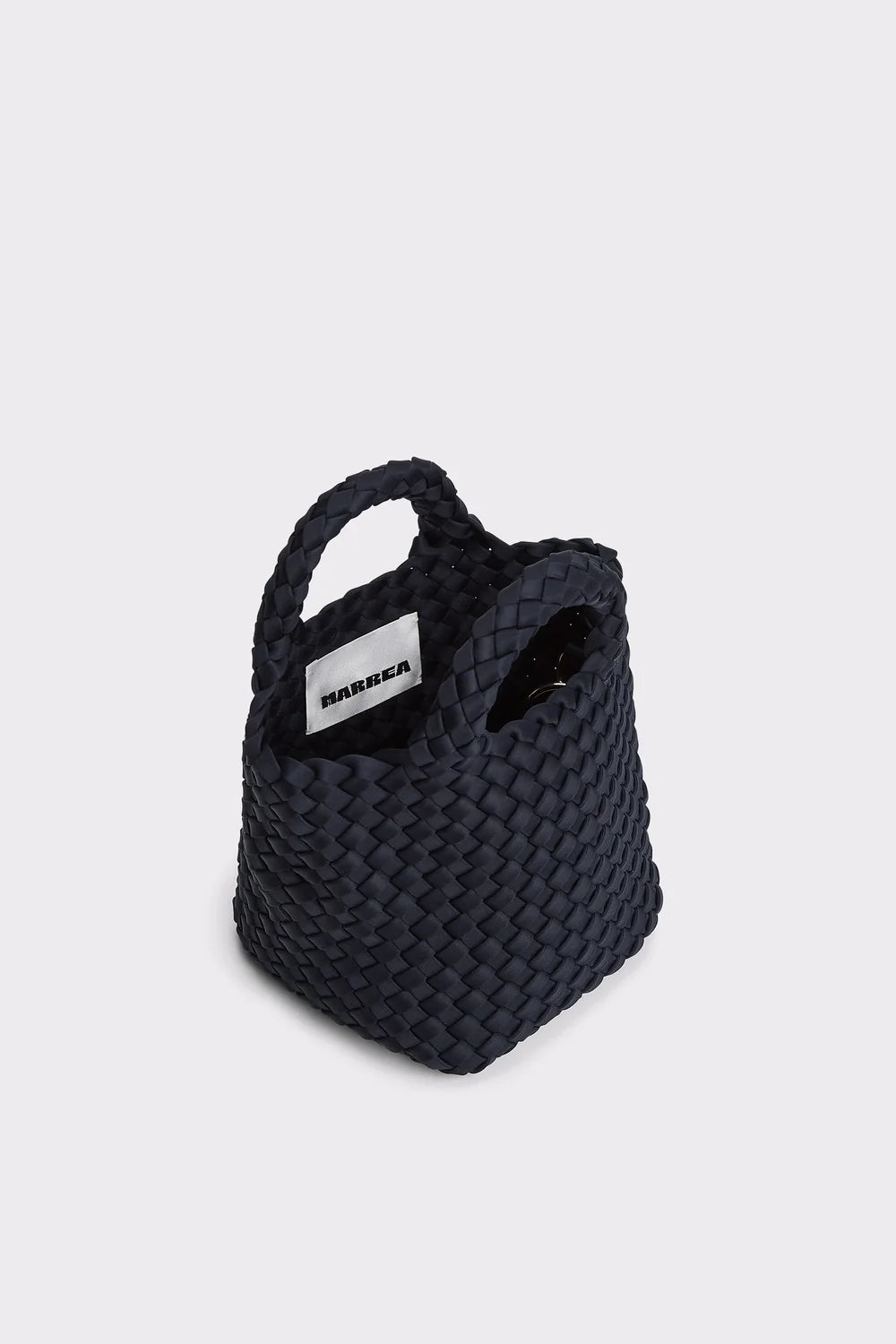 Black woven bag with a visible brand label on a light gray background