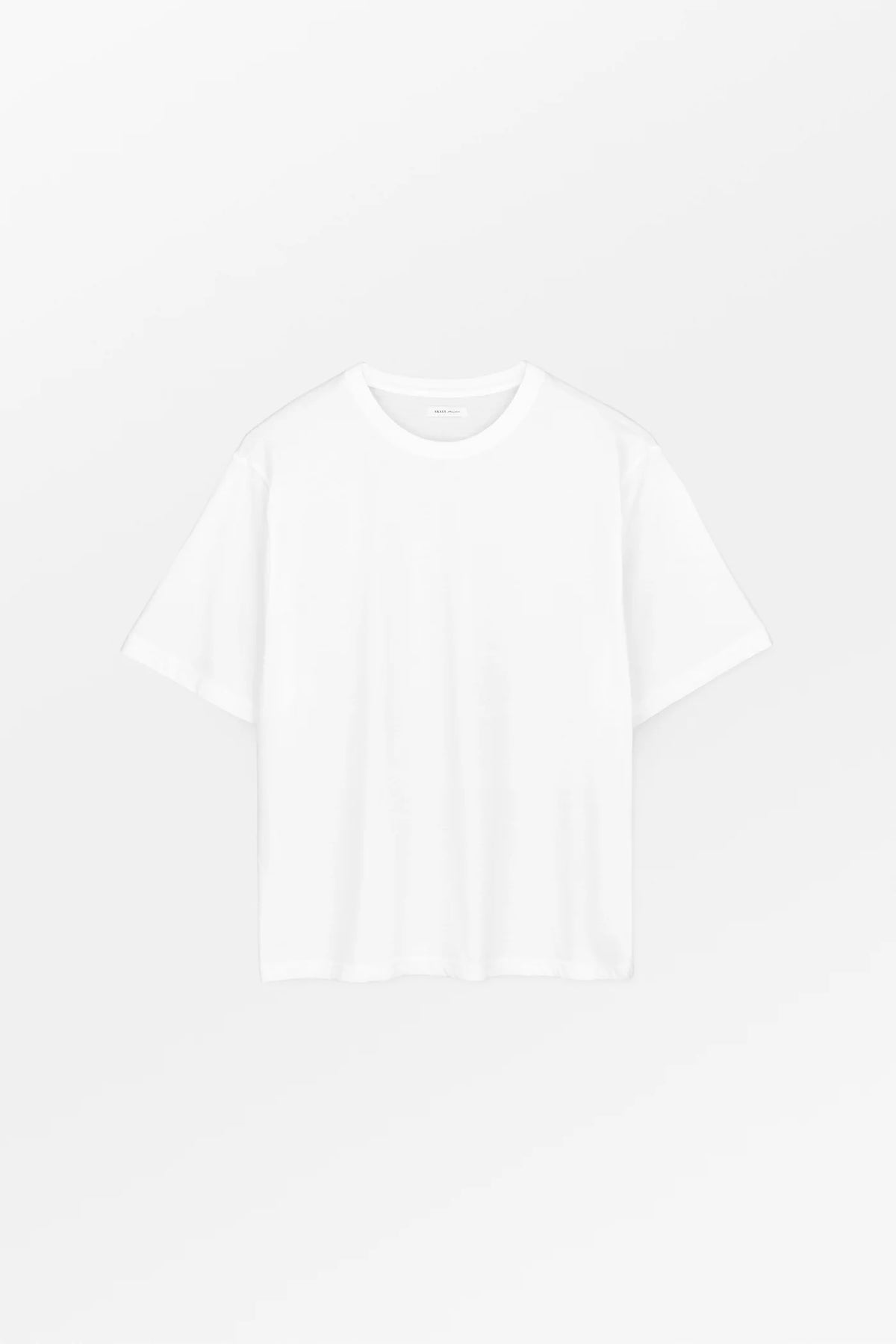 Plain white t-shirt on a light gray background