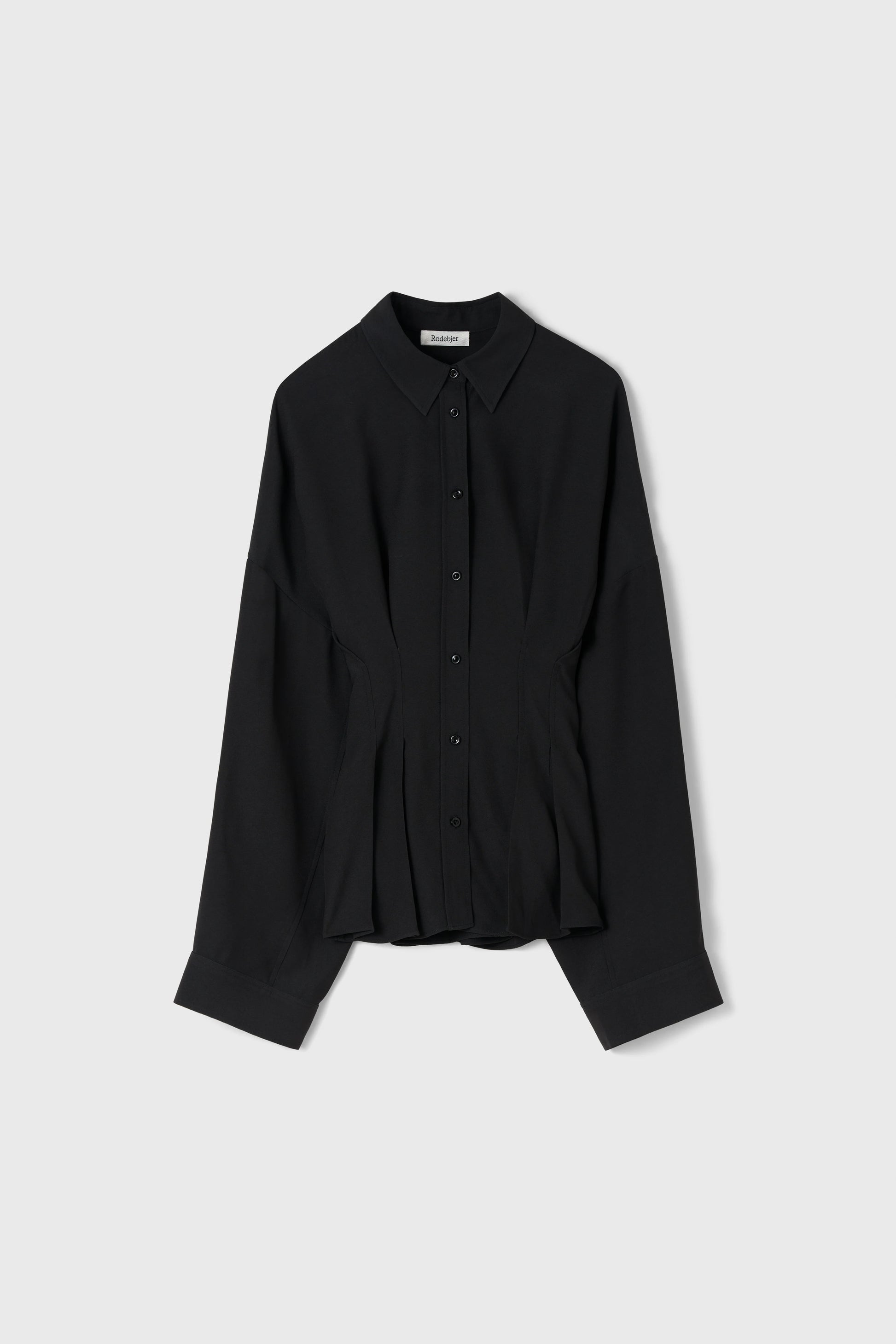 A black long-sleeve button-up shirt with a pointed collar and a subtle peplum-like gathered waist detail, displayed flat against a light gray background.
