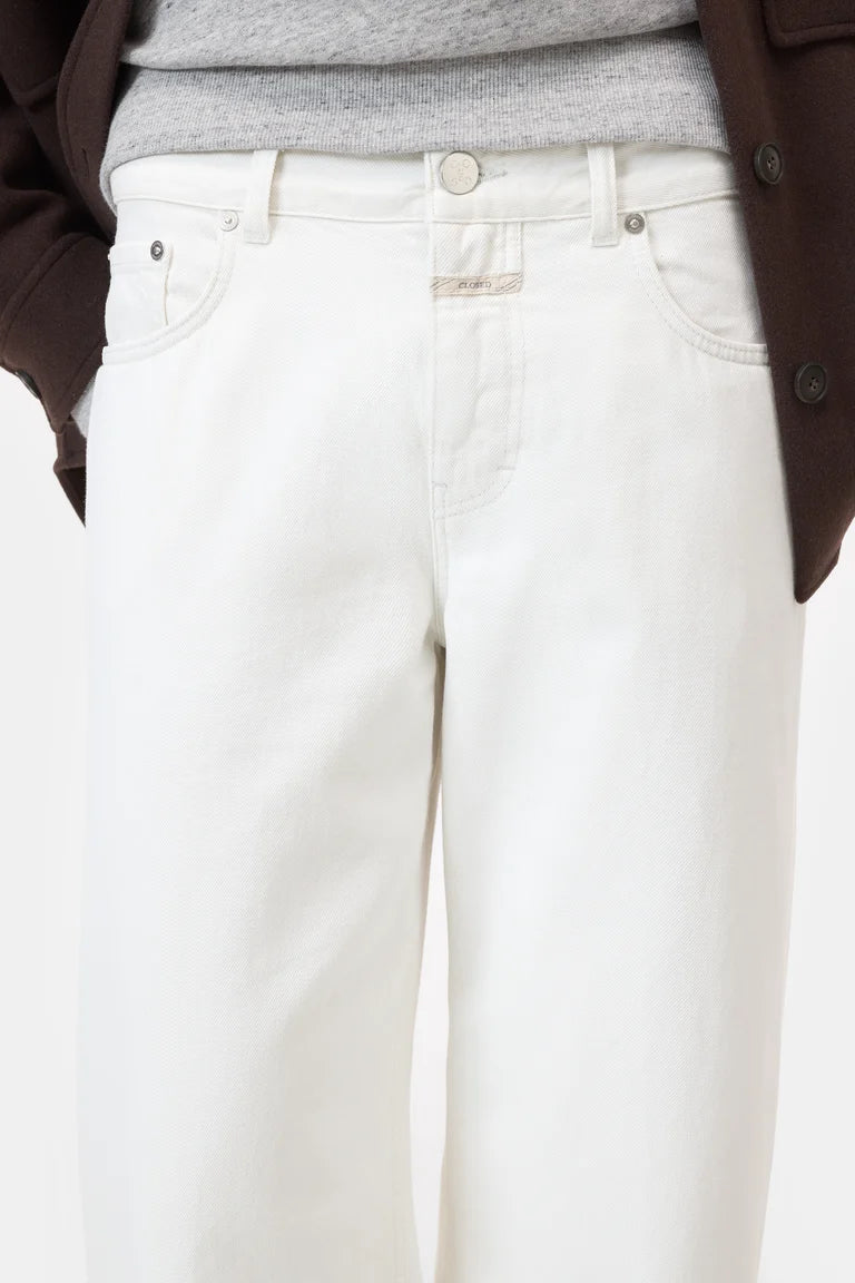 White pants worn by a person with a neutral background