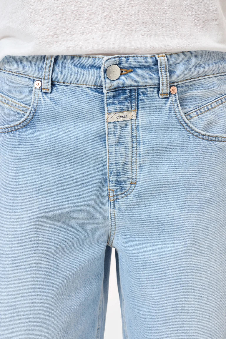 Light blue jeans with a brand label on a white background