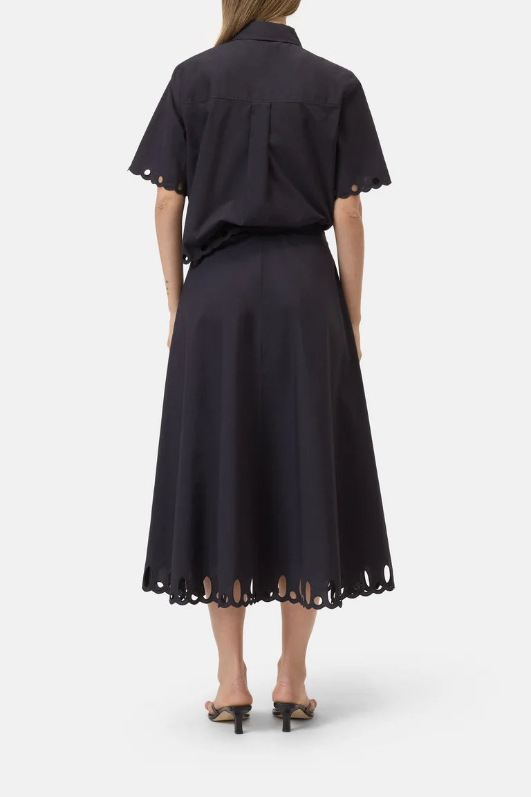 Black dress with short sleeves and hem details on a white background