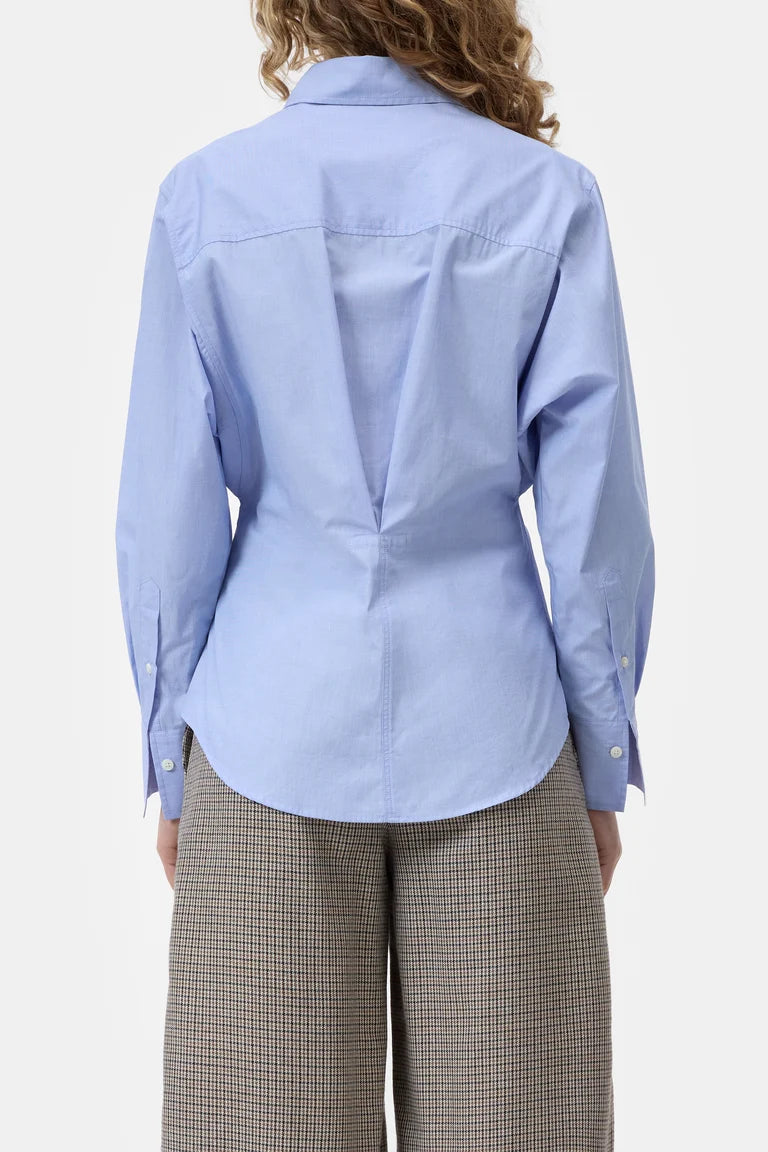 Light blue shirt worn by a person on a white background