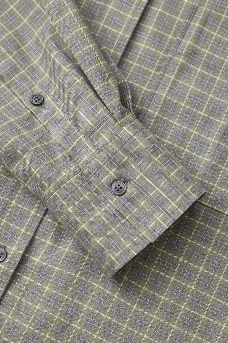 Close-up of a gray checkered suit jacket with buttons.
