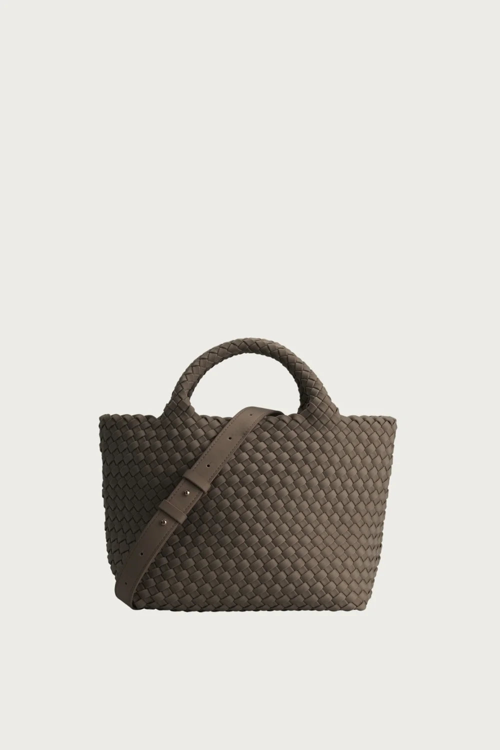 A woven leather top-handle tote bag in a dark taupe-brown color, featuring a matching shoulder strap and a structured, basketweave texture, set against a solid light gray background.