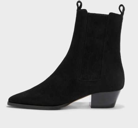 A single black suede ankle boot with a pointed toe, a low block heel, and elastic side gore, shown in profile against a light gray background.