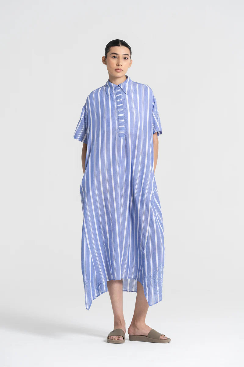 Person wearing a blue and white striped dress on a white background