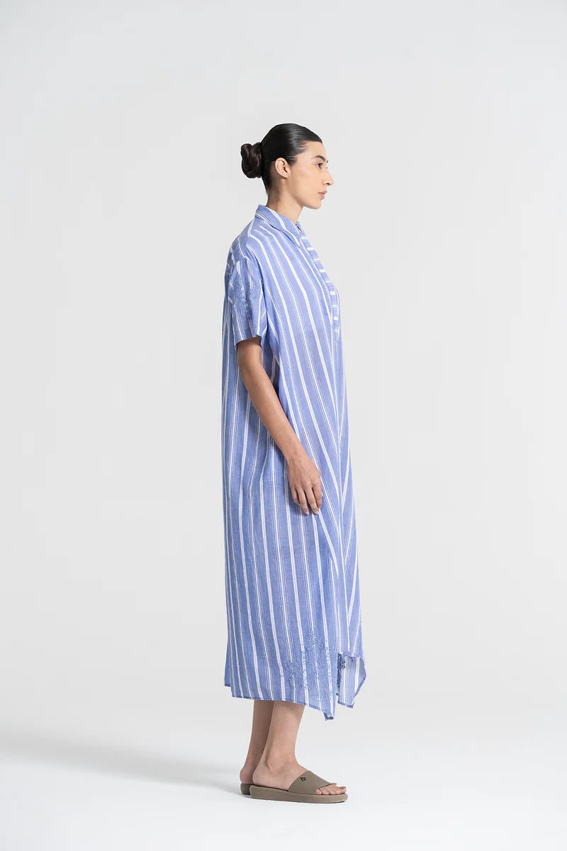 Woman wearing a blue and white striped dress on a white background