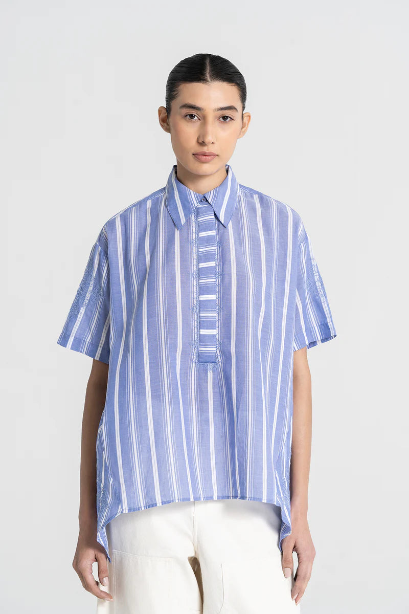 Person wearing a blue and white striped shirt on a white background