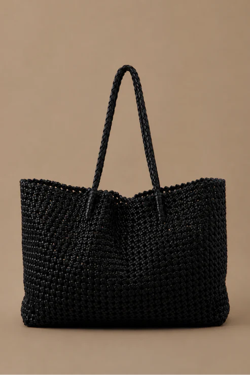 Black woven handbag on a beige background