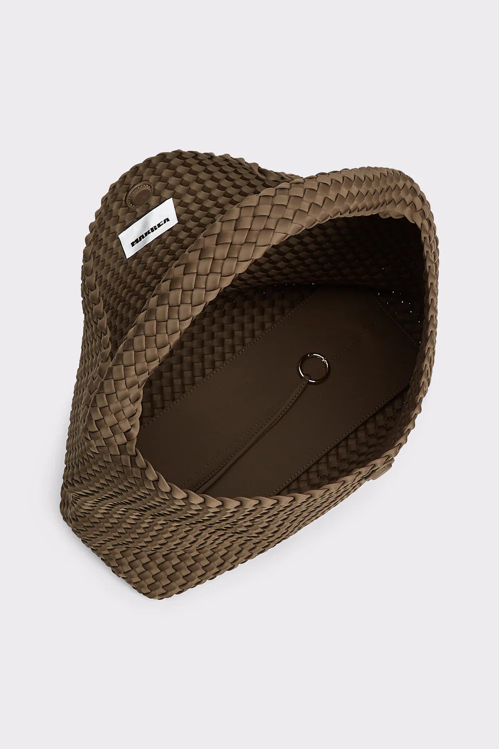 A brown woven straw hat with a white brand label reading 'MADRID' on the side, photographed from an overhead angle against a light gray background.