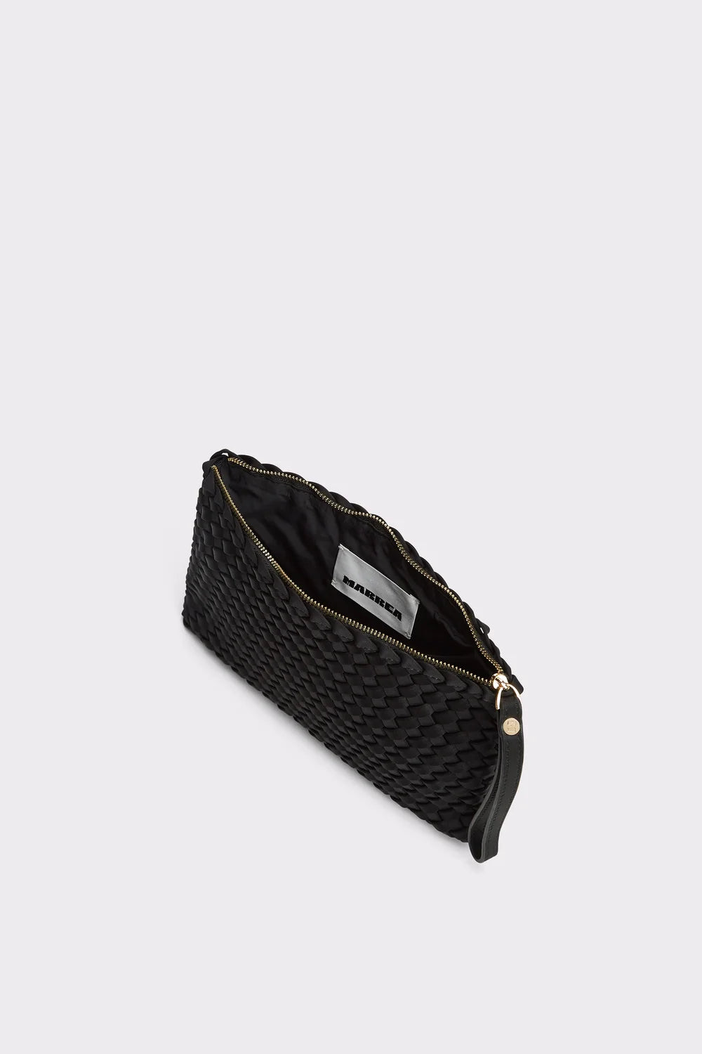 A black woven leather clutch bag with a gold zipper and a white interior label, shown on a light gray background.