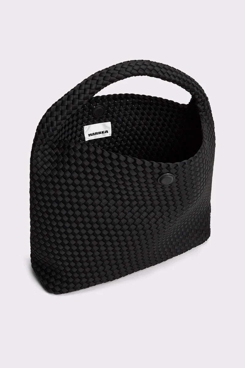 A black woven basket-style bag with a top handle and a small white label reading 'MAMMONA' on a light gray background.