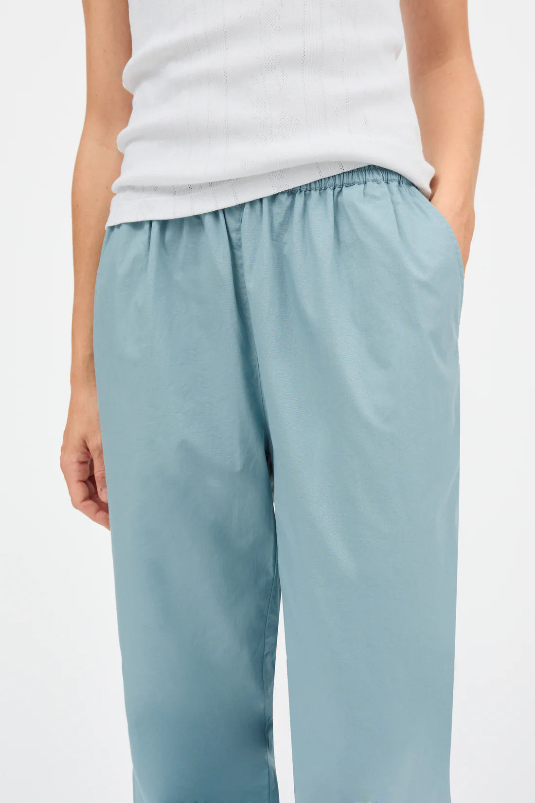 Light blue pants worn by a person on a white background