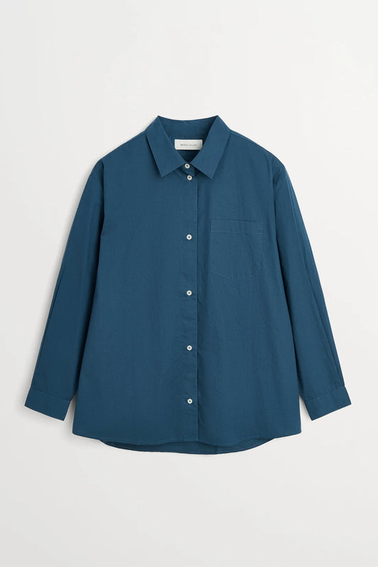 A slate blue long-sleeve button-up shirt with a pointed collar and a chest pocket, displayed flat against a light gray background.