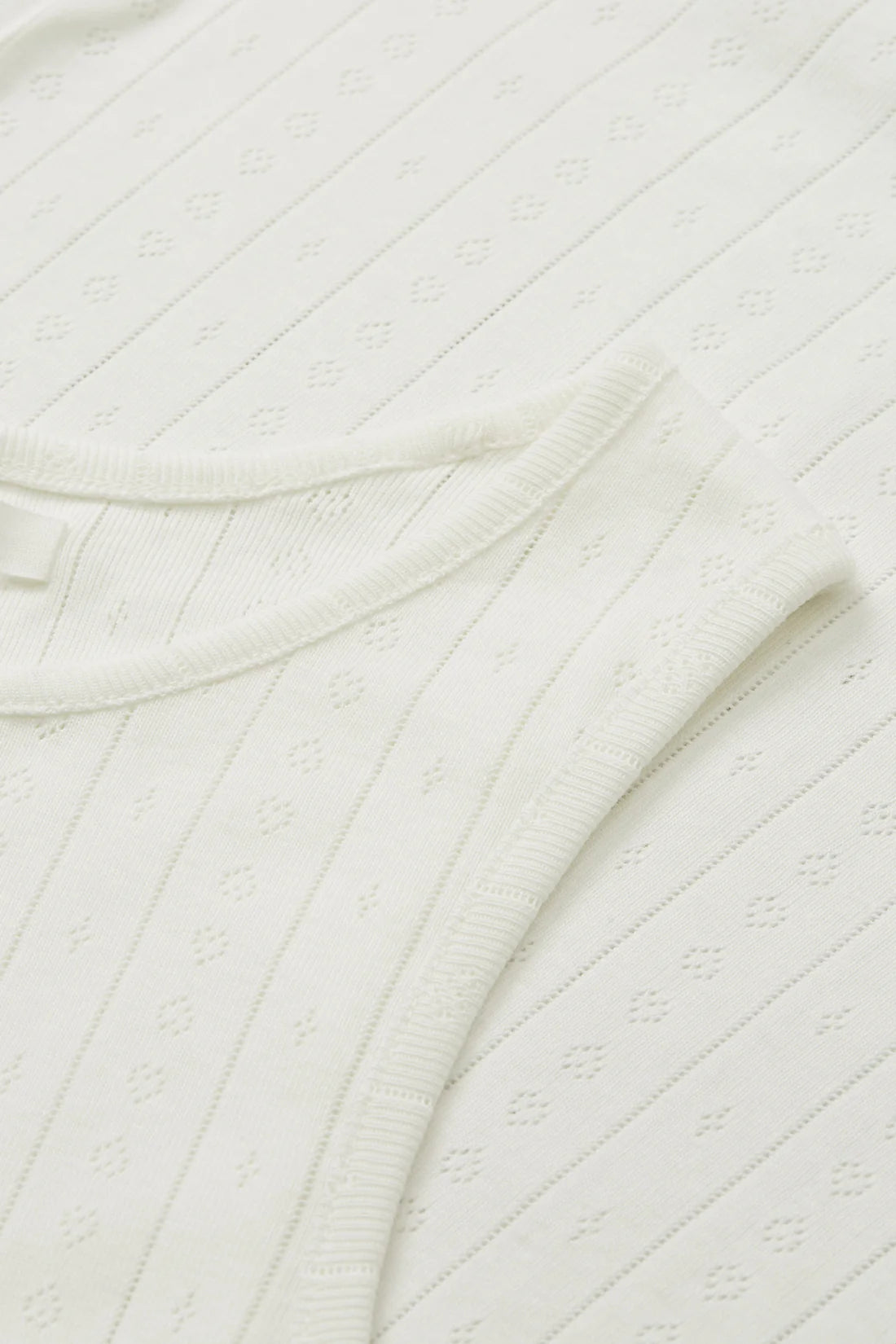 Close-up of a textured white fabric with folds