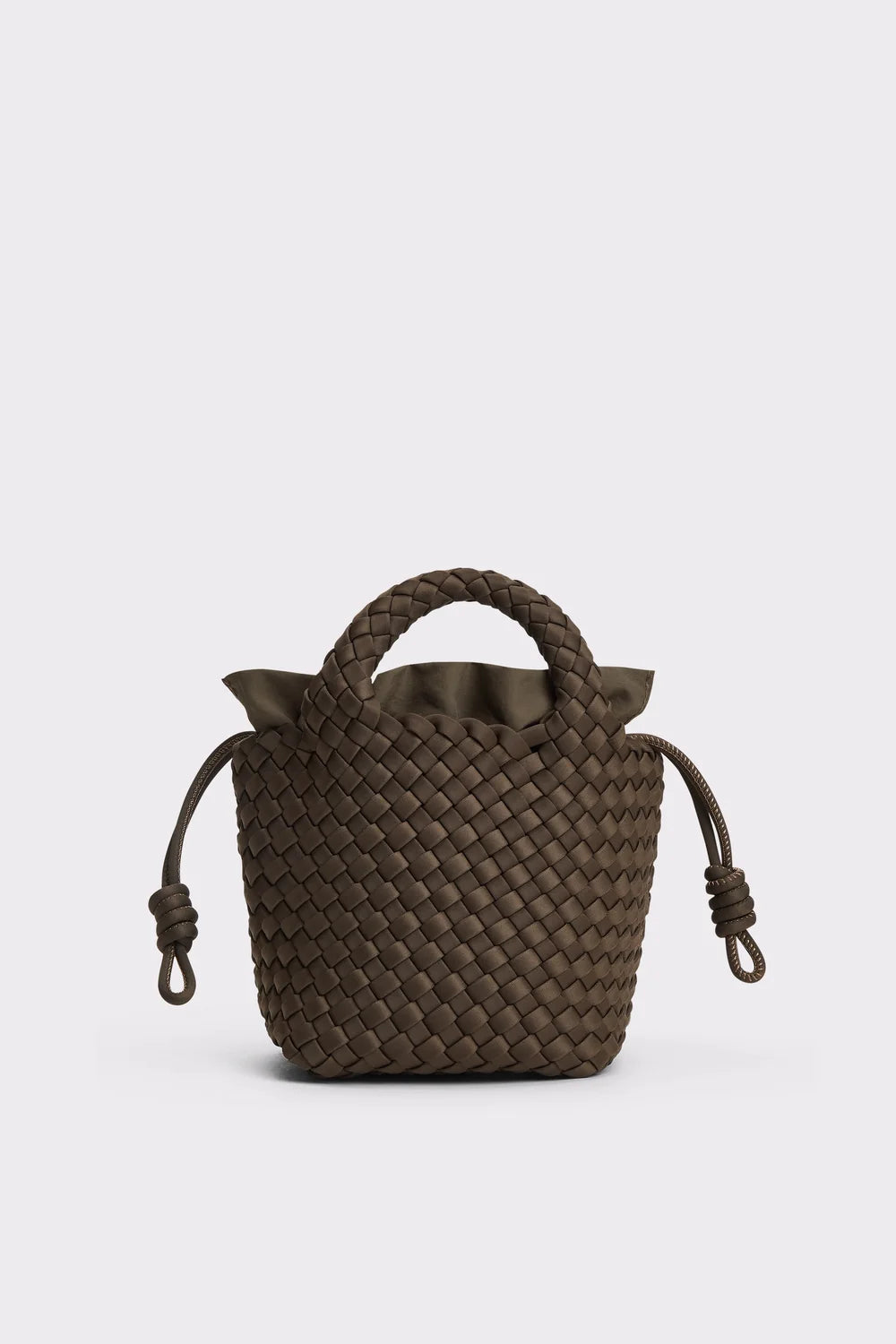 A dark brown woven leather bucket bag with top handles and drawstring ties, photographed against a light gray studio background.