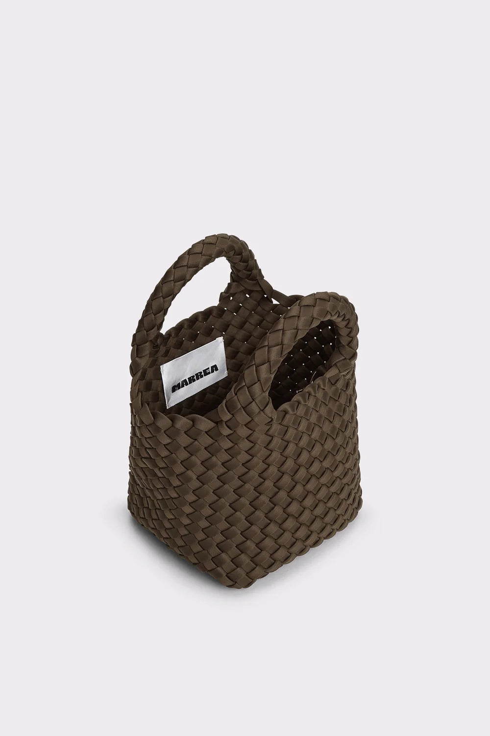 A dark brown woven leather tote bag with integrated handles and a white rectangular brand tag reading 'HANSSEN' on the side, set against a plain light gray background.