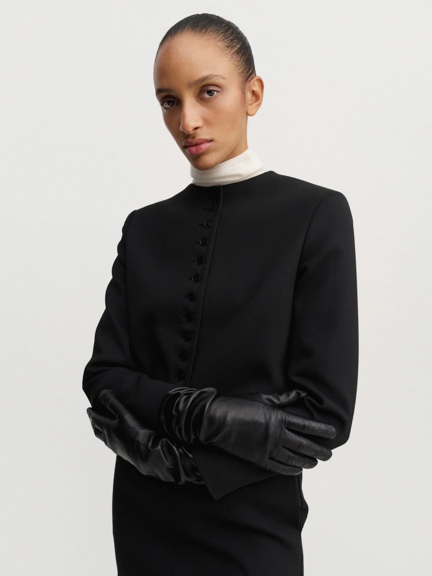 Woman wearing a black outfit with a white background