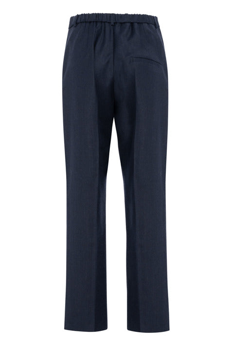 A pair of dark navy blue trousers with an elastic waistband and a side pocket, shown from the back against a plain white background.