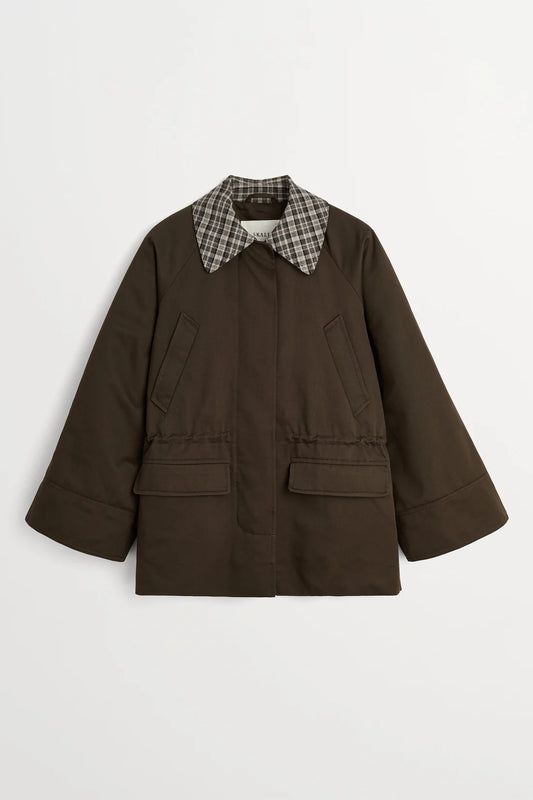 Green jacket with button details on a white background